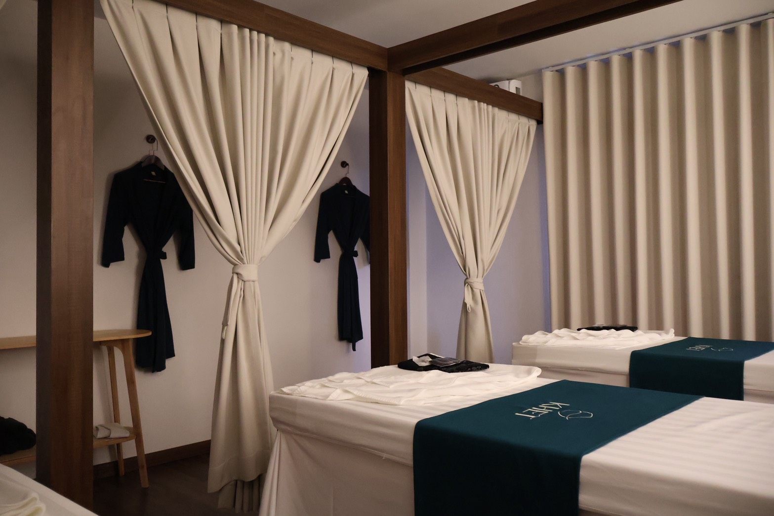 KHET Massage — canopy massage beds with signature teal linen
