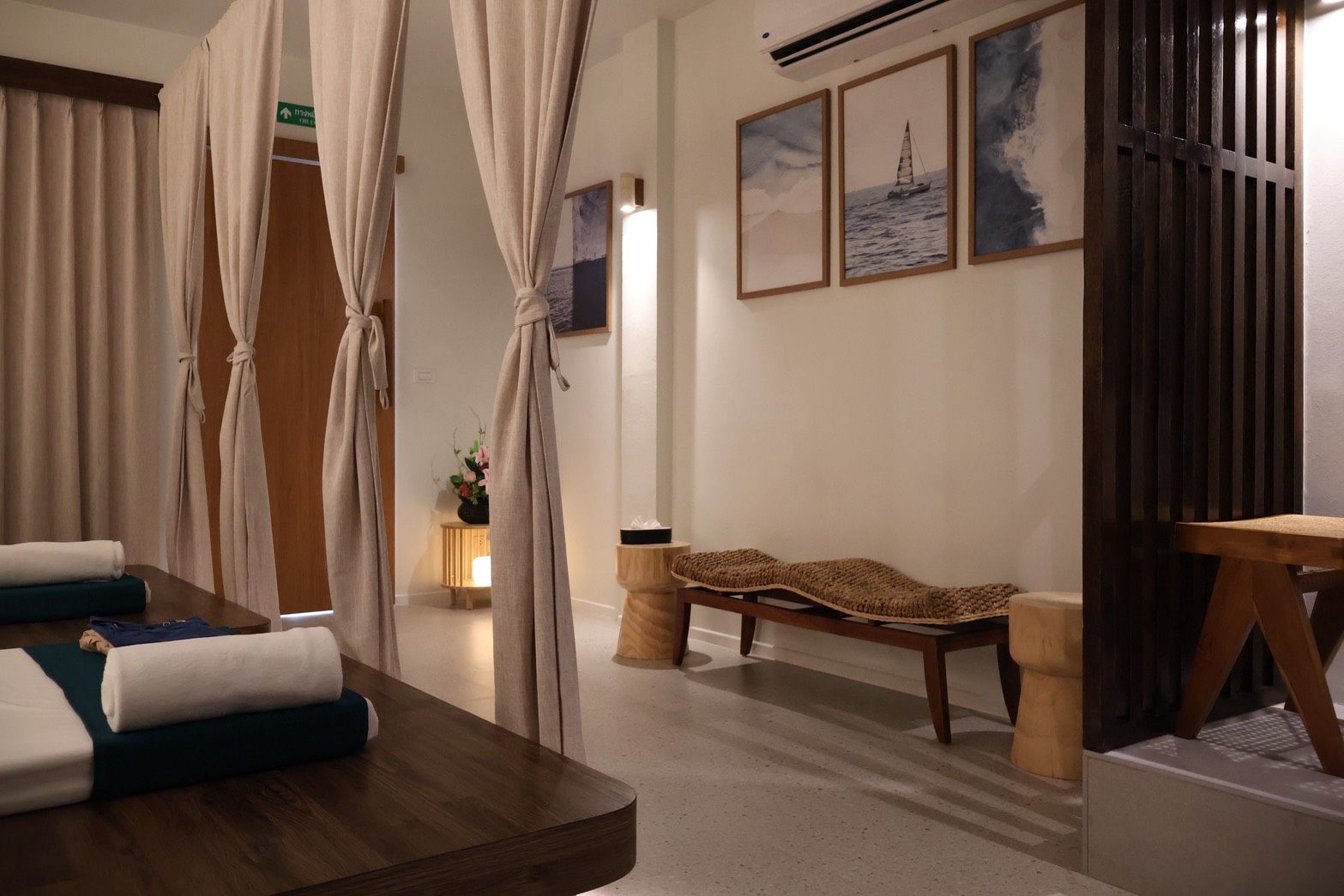 KHET Massage — relaxing lounge corridor with ocean-themed artwork