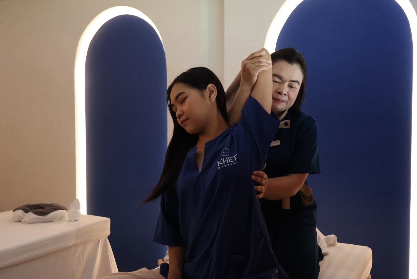 KHET Massage — professional therapist performing traditional Thai stretch